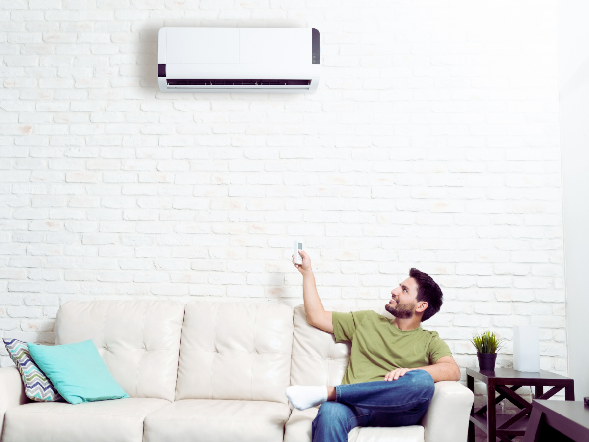 homeowner turning on mini-split ductless system