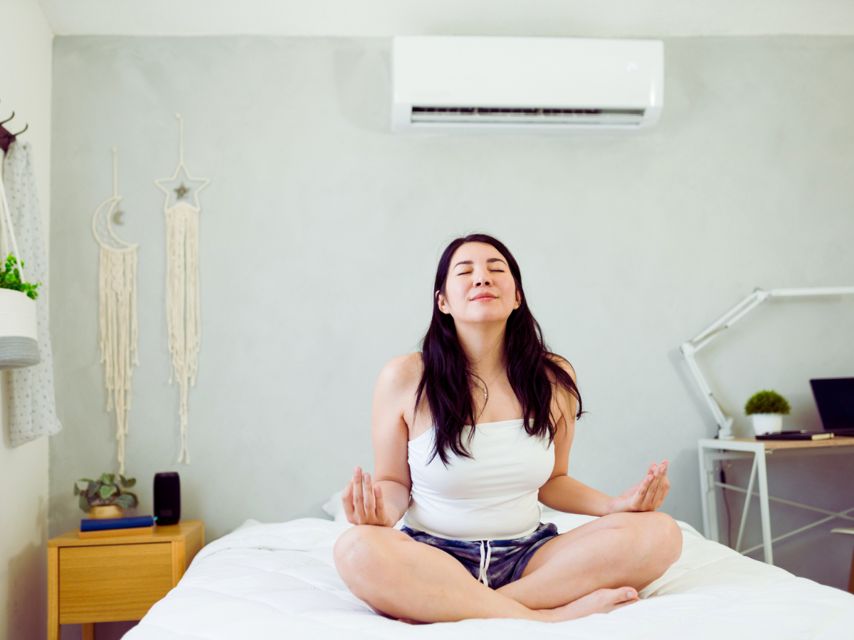 female homeowner enjoying benefits of mini split ductless ac system