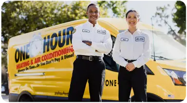 Two One Hour Air Conditioning & Heating technicians standing confidently in front of their yellow service van.