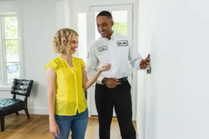 One Hour tech showing homeowner how to calibrate thermostat